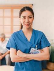 Professional caregiver smiling with arms crossed