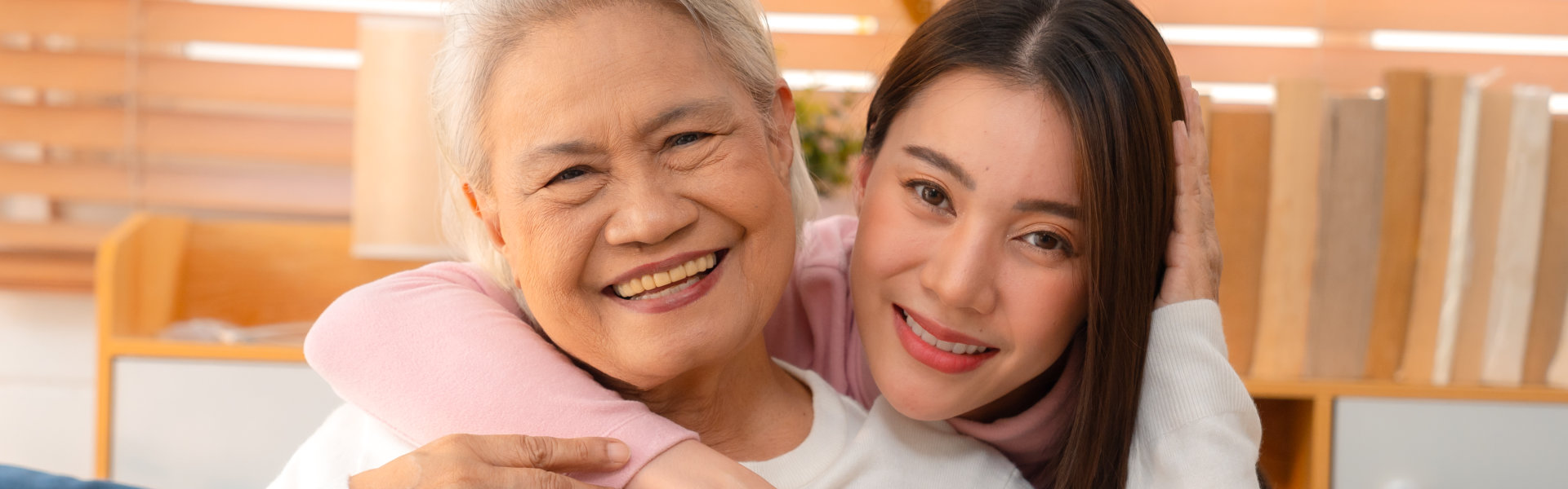 Elderly woman smiling with her caregiver